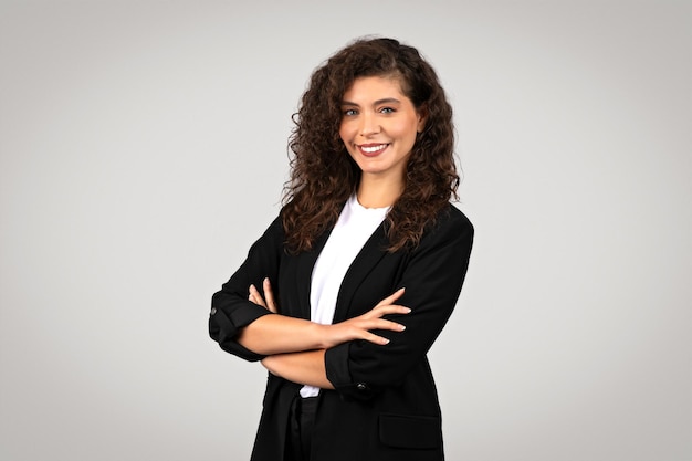 Confident businesswoman with crossed arms smiling