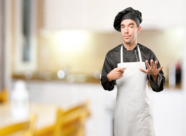 Confident chef with a keep calm gesture