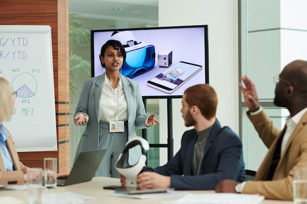 Confident coach or speaker making presentation in front of audience