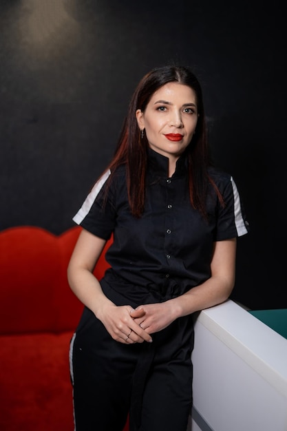 Confident cosmetologist smiling while posing at her studio Beautician female looking at the camera Permanent makeup concept