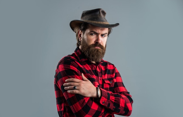 Confident cowboy man with stylish facial hair, beard and mustache.