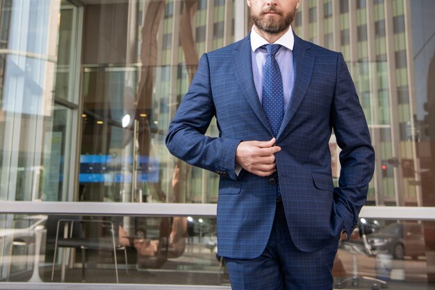 Confident cropped boss businessman in formal suit business success successful man