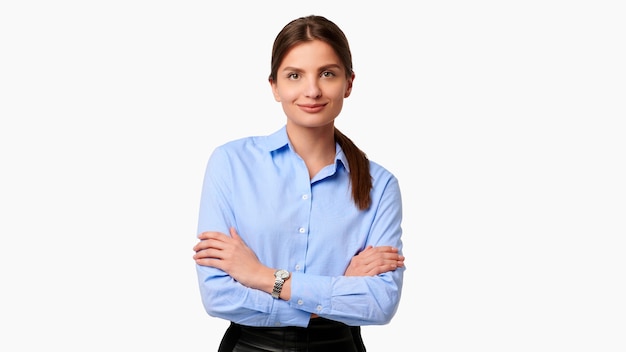 Confident crossed arms businesswoman in blue shirt on white isolated