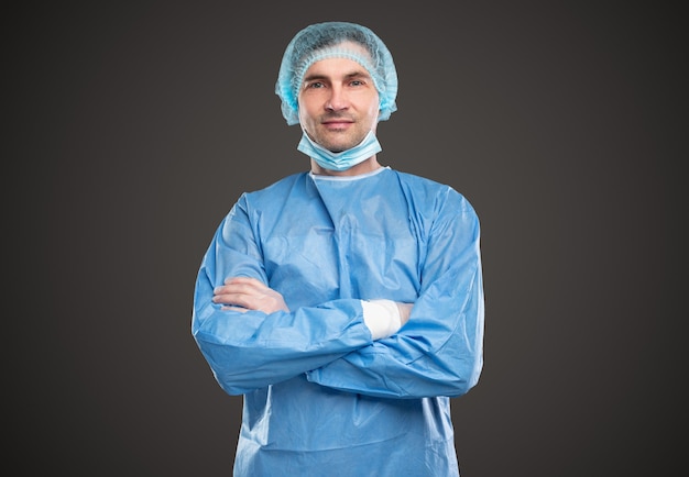 Confident doctor in disposable uniform