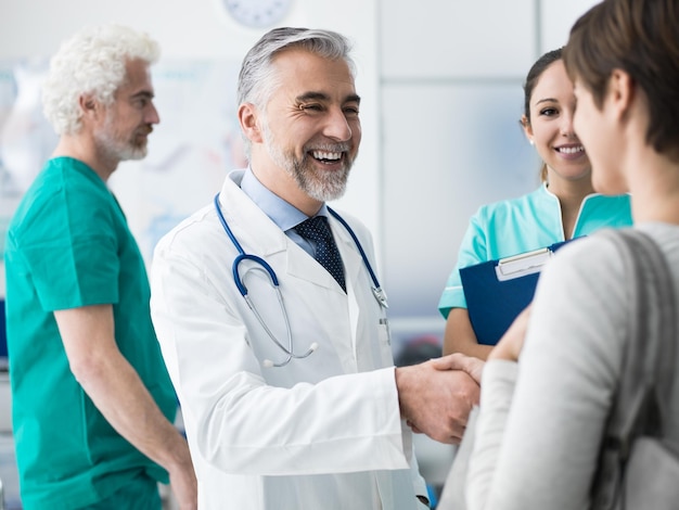 Confident doctor shaking patient's hand