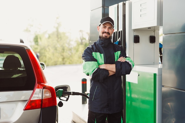 Confident employee refueling car