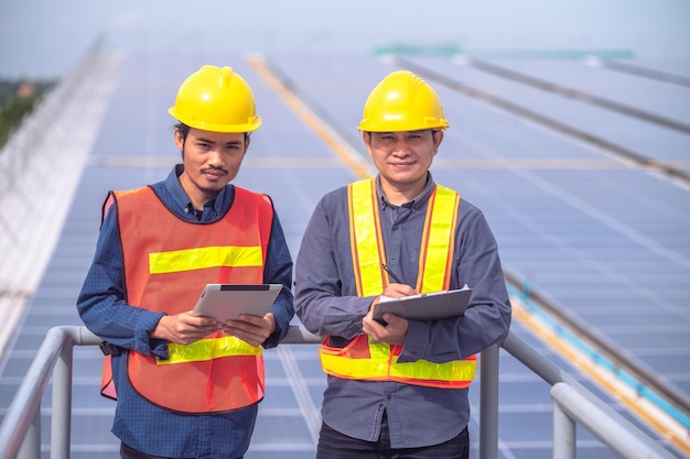 Confident Engineer standing check on Solar power energy at rooftop factory