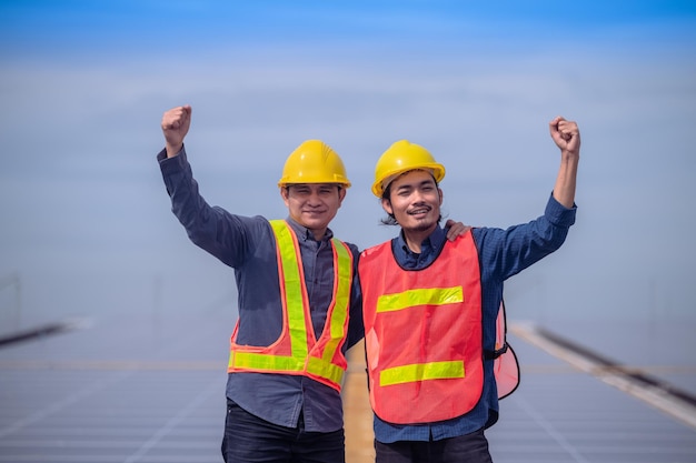 Confident Engineer standing check on Solar power energy at rooftop factory