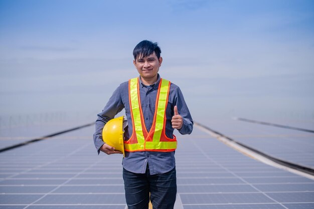 Confident Engineer standing check on Solar power energy at rooftop factory