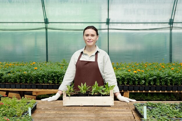 Confident farmer in workwear standing by workplace