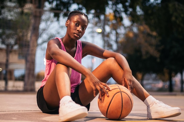 confident female basketball player on the court