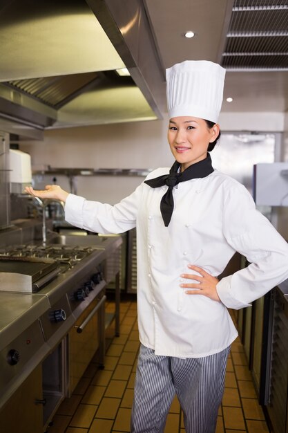 Confident female cook in kitchen