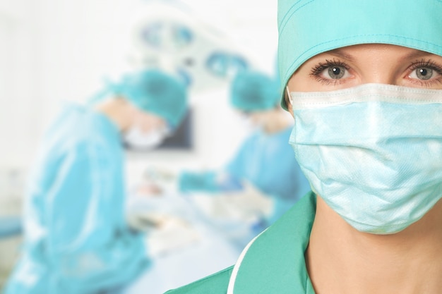 Confident female doctor in mask in clinic