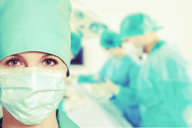 Confident female doctor in mask in clinic