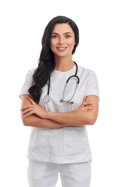 Confident female doctor in medical uniform with stethoscope on neck standing on white