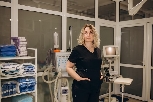 Confident female doctor sitting at office desk and smiling at camera health care and prevention concept