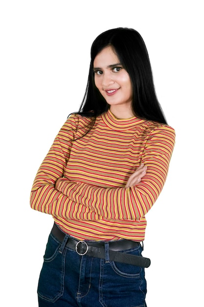 Confident girl stands with folded arms on studio