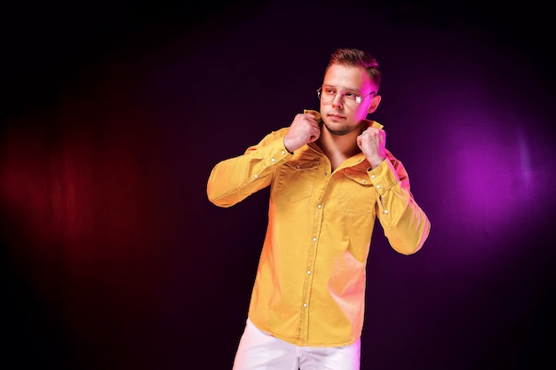 Confident guy adjusting shirt during party