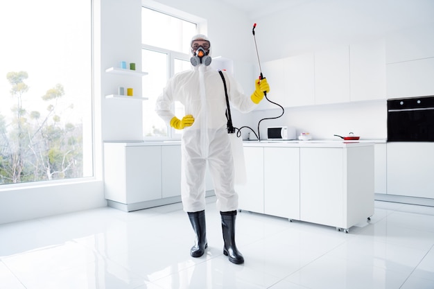 confident guy cleaner worker in white hazmat suit