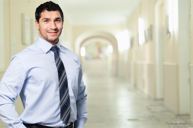 Confident handsome businessman on background