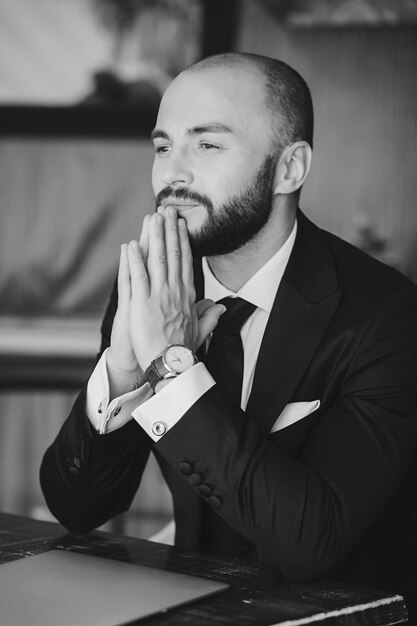 Confident, handsome man in a black suit. successful broker