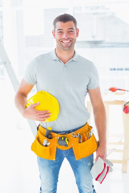 Confident handyman standing at construction site