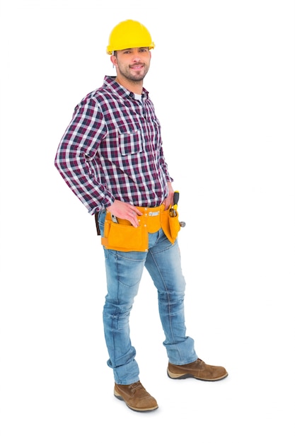 Confident handyman standing with hands on hips