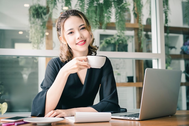 Confident happiness young woman working on laptop or notebook in her office.