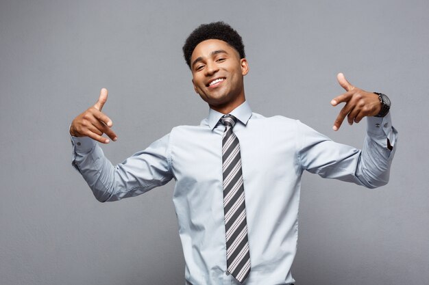 Confident happy young African American pointing two hands to himself. 