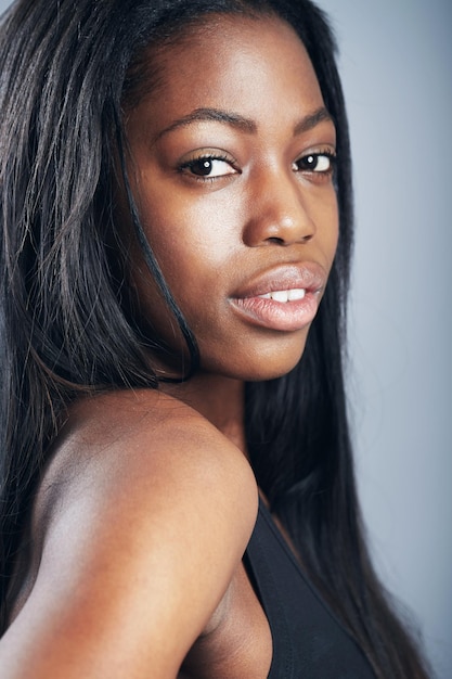 Confident in her natural beauty a young woman in casual wear looking at the camera