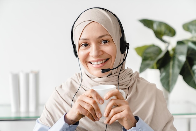 Confident it support worker islamic arabian woman in hijab hot\
line occupation on remote lockdown