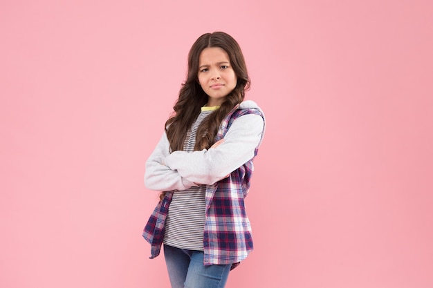 Photo confident kid with pouty look keep arms crossed in casual fashion style pink background confidence