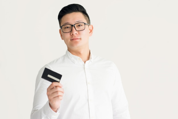 Confident Korean businessman using credit card