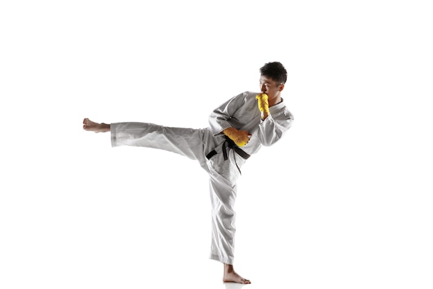 Confident korean man in kimono practicing hand-to-hand combat, martial arts