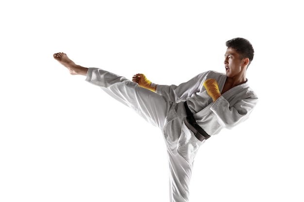 Confident korean man in kimono practicing hand-to-hand combat, martial arts