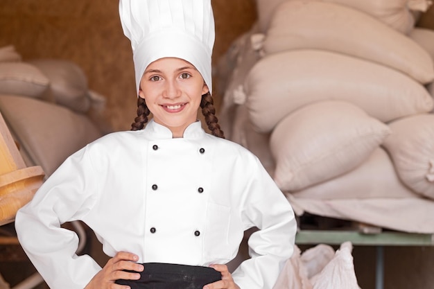 Confident little chef in flour storage