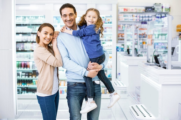 Confident loving family coming in drugstore and looking at camera