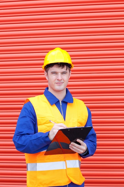 Confident male engineer writing his report 