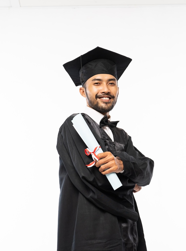 Photo confident male graduate wearing a toga and holding a roll of certificate paper on a white background