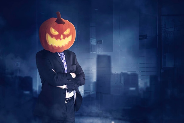 Confident male manager with head of pumpkin