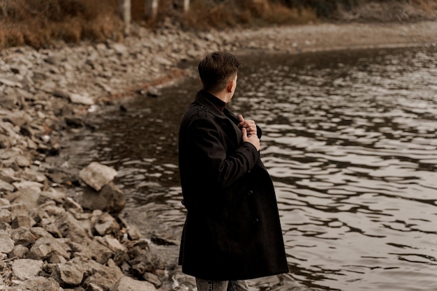 Confident male model wearing black coat