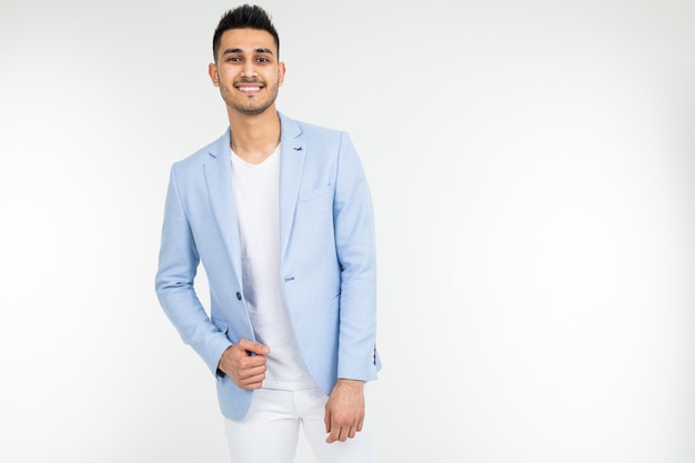 Confident man in a blue jacket posing on a white with copy space