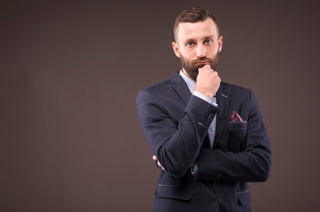 Confident man leaned his hand to his beard