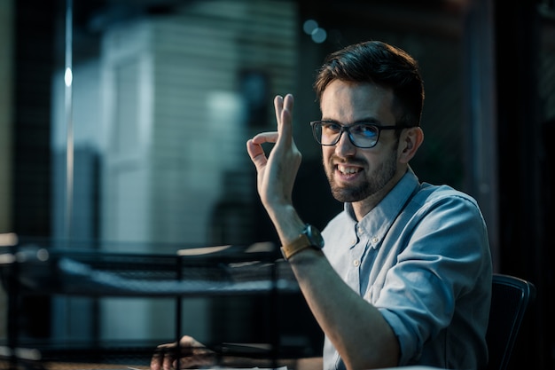 Confident man showing OK gesture