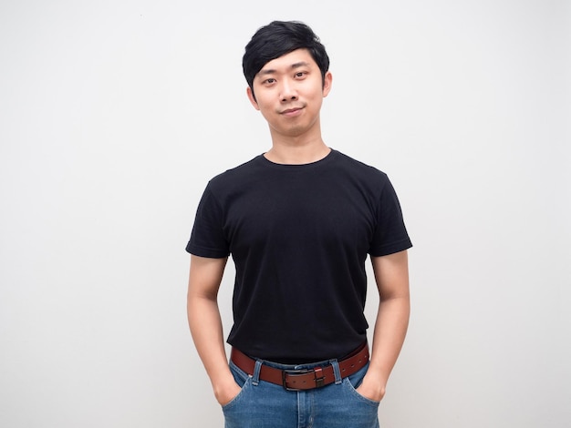 Confident man stand hand in pocket jeanHandsome asian man studio shot isolated