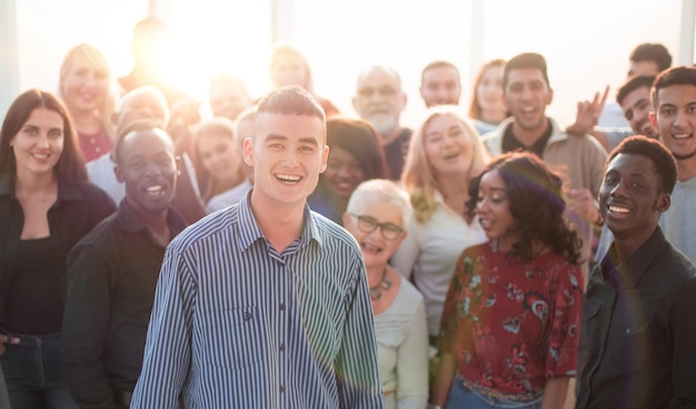 Confident man standing in front of a team of young like minded people