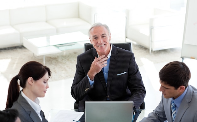 Confident manager smiling at the camera in a meeting 