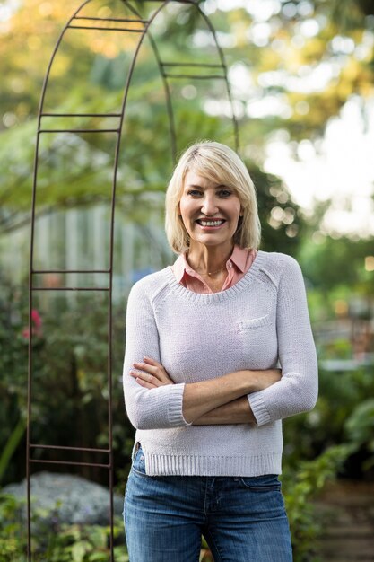 Confident mature woman against greenhouse