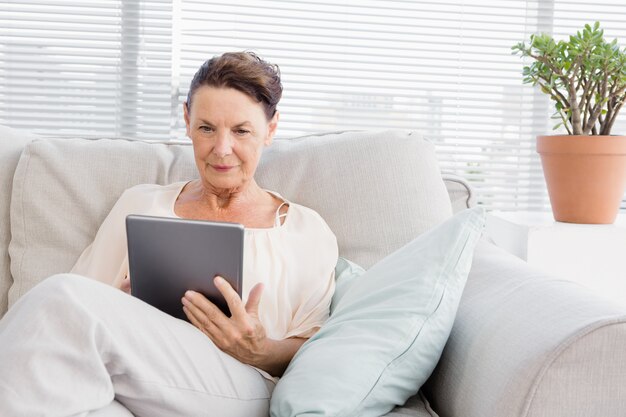 Confident mature woman using digital tablet