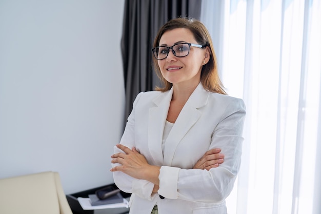 Confident middle aged business woman looking at camera